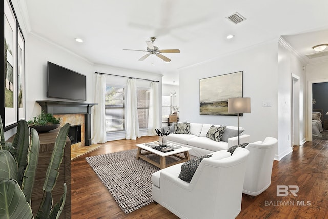 living room featuring ceiling fan, dark hardwood / wood-style flooring, and crown molding