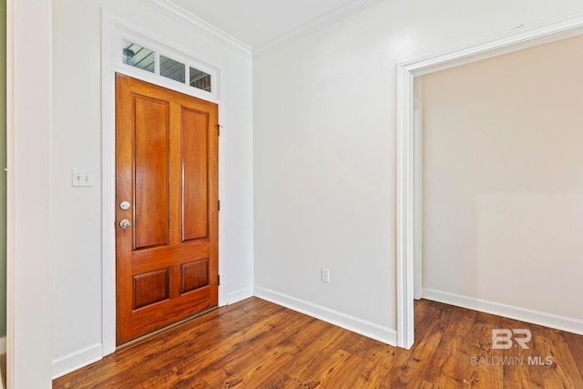 foyer entrance with dark hardwood / wood-style floors and ornamental molding