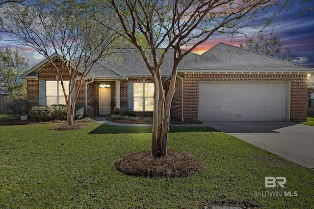 view of front of home with a yard and a garage