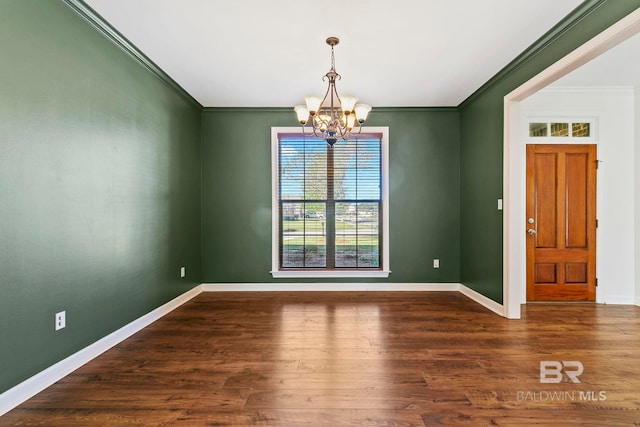 interior space with an inviting chandelier, baseboards, and wood finished floors