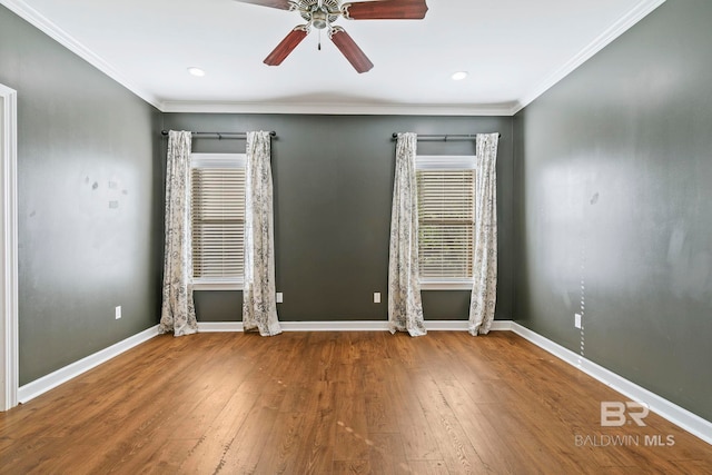 empty room with baseboards, a ceiling fan, hardwood / wood-style flooring, and crown molding