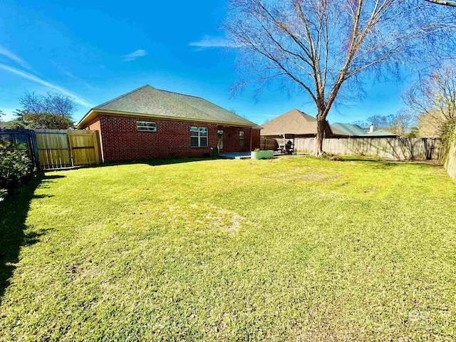 view of yard with a patio area and a fenced backyard