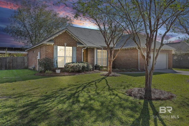 single story home with a garage, brick siding, fence, and a front lawn