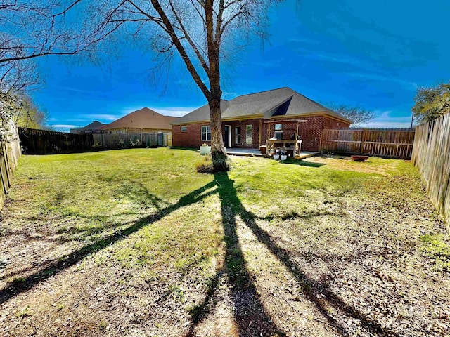 view of yard with a fenced backyard