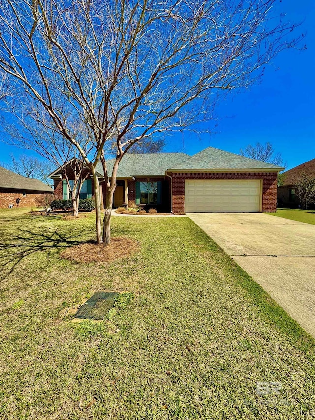 single story home featuring a garage, driveway, a front lawn, and brick siding