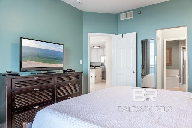 455 E Beach Blvd Unit 1505, Gulf Shores, AL 36542 - bedroom with visible vents, stainless steel refrigerator with ice dispenser, and ensuite bath
