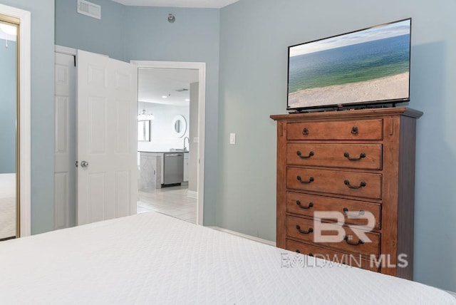 455 E Beach Blvd Unit 1505, Gulf Shores, AL 36542 - bedroom with visible vents, light tile patterned floors, and ensuite bathroom