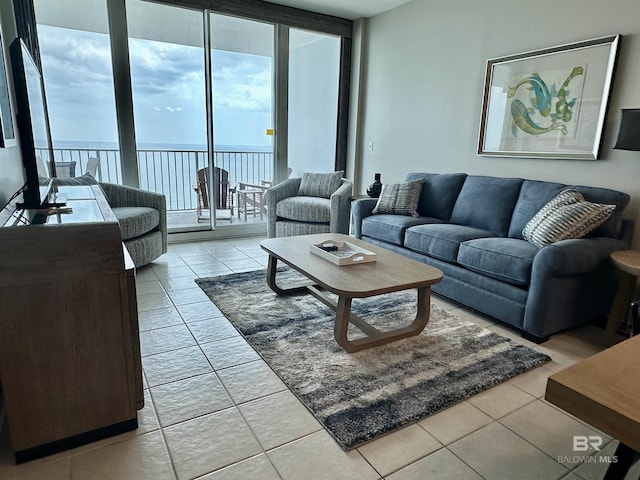 455 E Beach Blvd Unit 1505, Gulf Shores, AL 36542 - tiled living room with a water view and a wall of windows