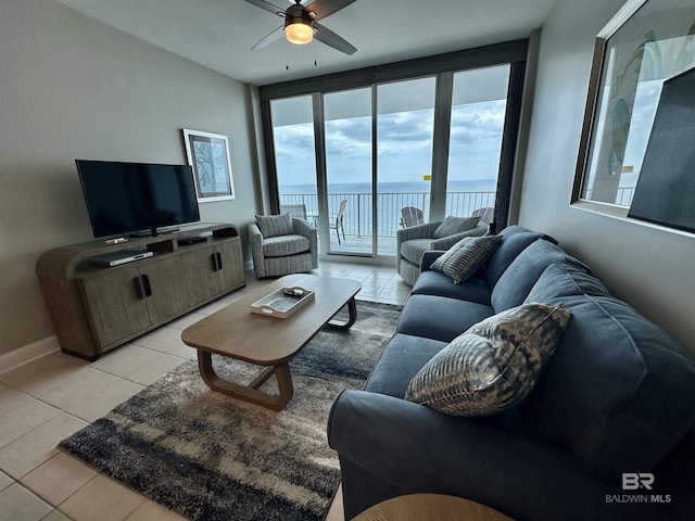 455 E Beach Blvd Unit 1505, Gulf Shores, AL 36542 - living room featuring light tile patterned floors, plenty of natural light, a ceiling fan, and baseboards