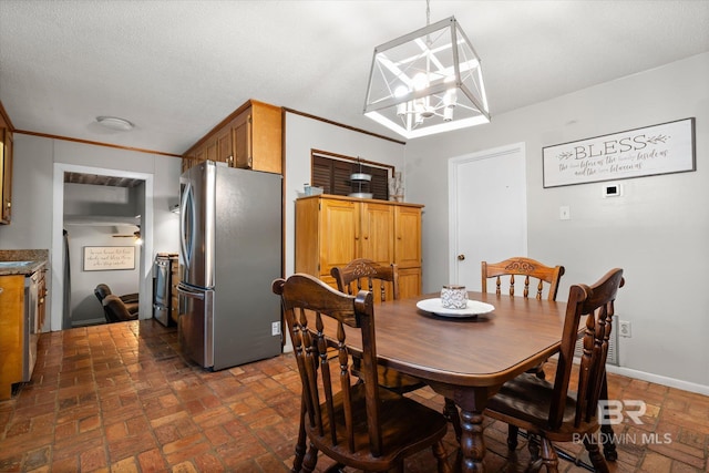 dining room featuring a notable chandelier and ornamental molding