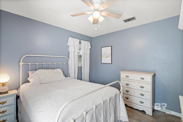 bedroom with ceiling fan and dark hardwood / wood-style floors