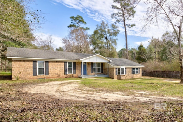 ranch-style home with a porch and a front lawn