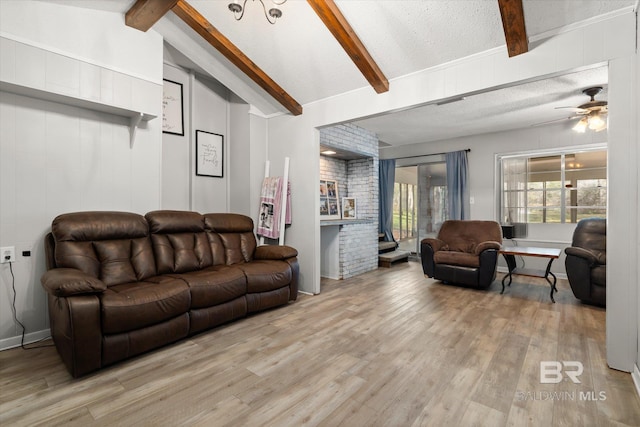 living room featuring light hardwood / wood-style flooring, ceiling fan, lofted ceiling with beams, and a textured ceiling