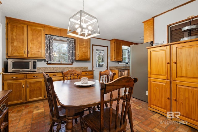 dining room with a chandelier and crown molding