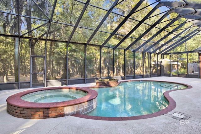 view of pool featuring a lanai, an in ground hot tub, and a patio