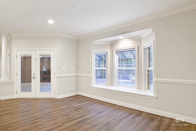 spare room featuring french doors, crown molding, and hardwood / wood-style floors