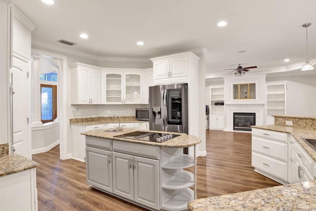 kitchen with stainless steel appliances, ceiling fan, sink, white cabinetry, and hanging light fixtures