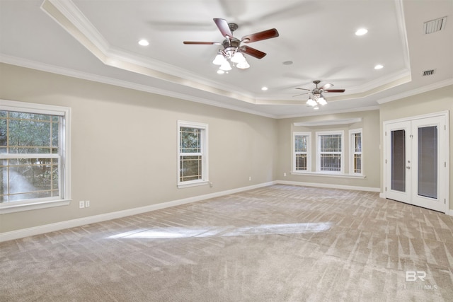 unfurnished room with a raised ceiling and ornamental molding