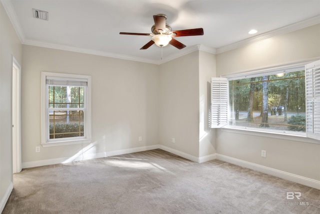 carpeted empty room featuring ceiling fan and ornamental molding