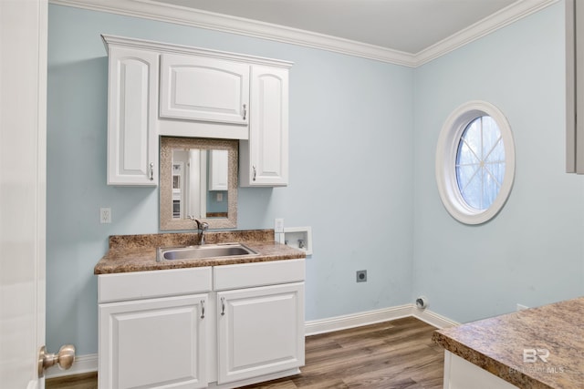 laundry area featuring electric dryer hookup, dark wood-type flooring, sink, washer hookup, and ornamental molding