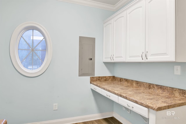 kitchen with white cabinets, electric panel, dark wood-type flooring, and ornamental molding