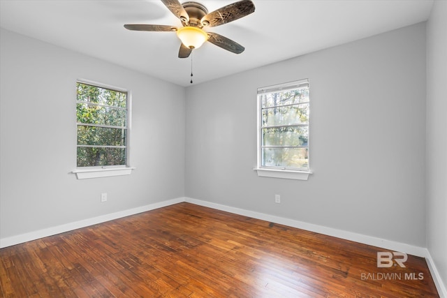 unfurnished room featuring ceiling fan, a healthy amount of sunlight, and wood-type flooring