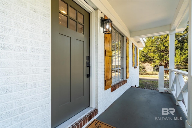 view of exterior entry with covered porch