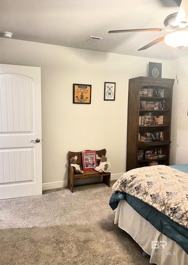 carpeted bedroom featuring baseboards, visible vents, and ceiling fan