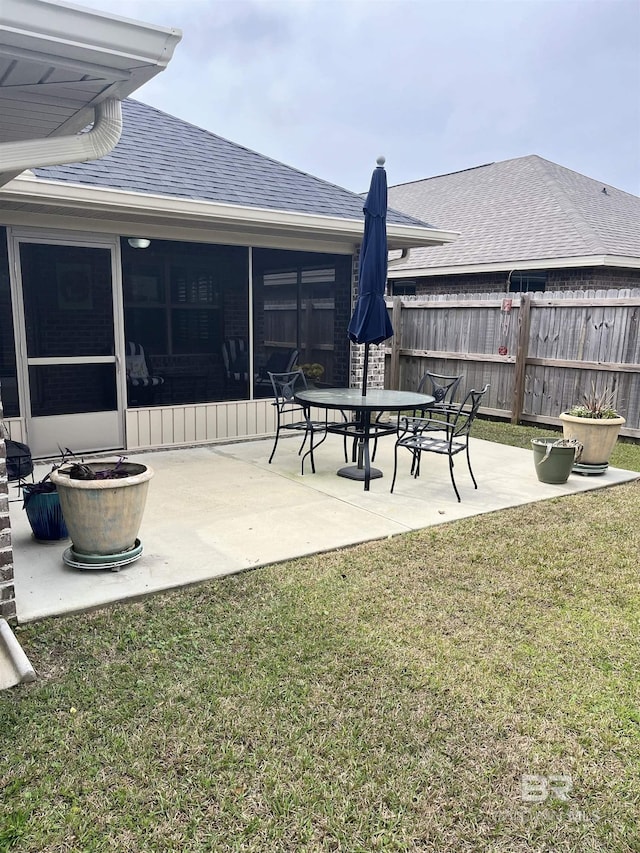 view of yard with a patio, a sunroom, and fence