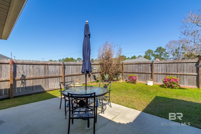 view of patio with outdoor dining space and a fenced backyard