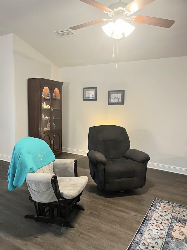 living area with a ceiling fan, visible vents, wood finished floors, and baseboards