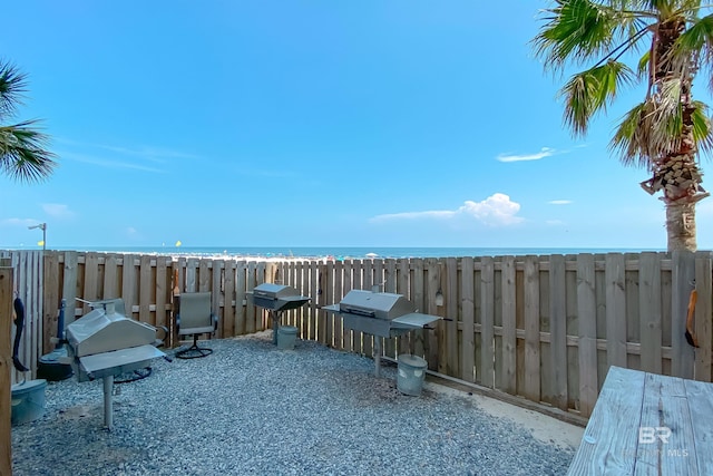 view of patio featuring a water view and area for grilling