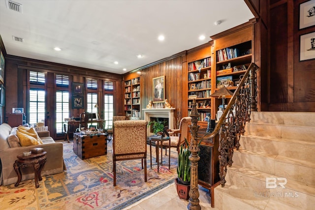 tiled office space featuring built in features, wood walls, french doors, and ornamental molding