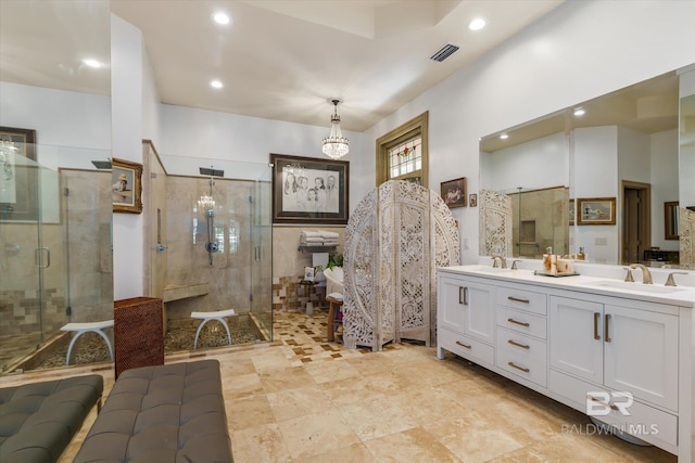 bathroom featuring tile patterned flooring, an enclosed shower, and vanity