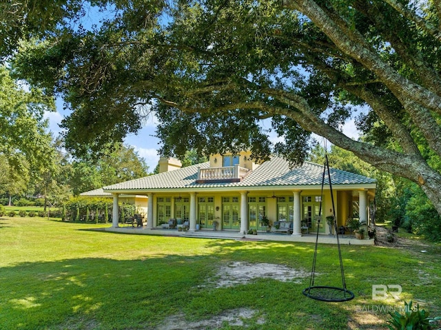 back of property featuring a lawn