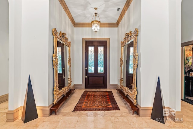 foyer with crown molding, light tile patterned floors, and a towering ceiling