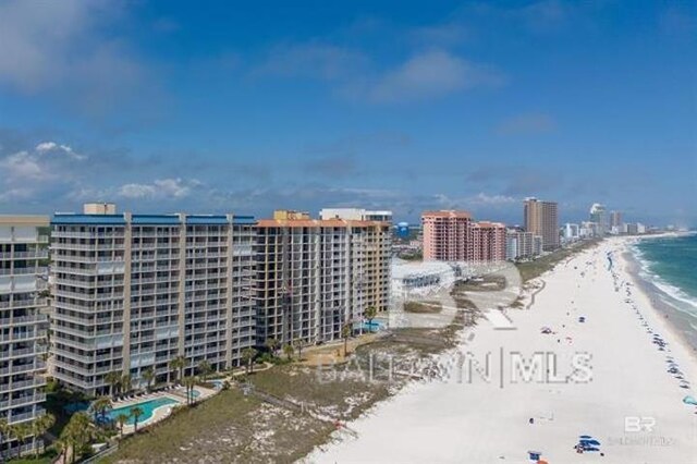 birds eye view of property with a view of the beach and a water view