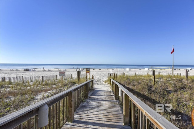 surrounding community featuring a view of the beach and a water view