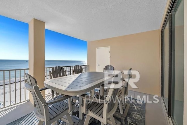 balcony with a view of the beach and a water view