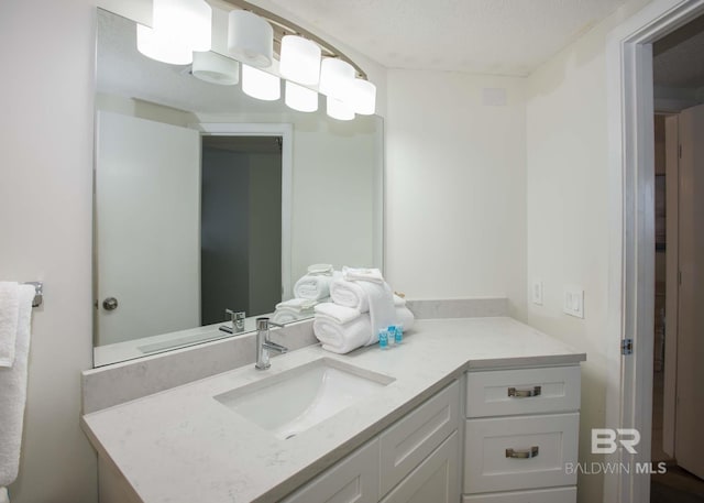 bathroom featuring vanity and a textured ceiling