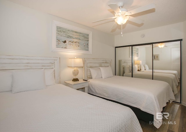 bedroom with hardwood / wood-style flooring, a closet, and ceiling fan