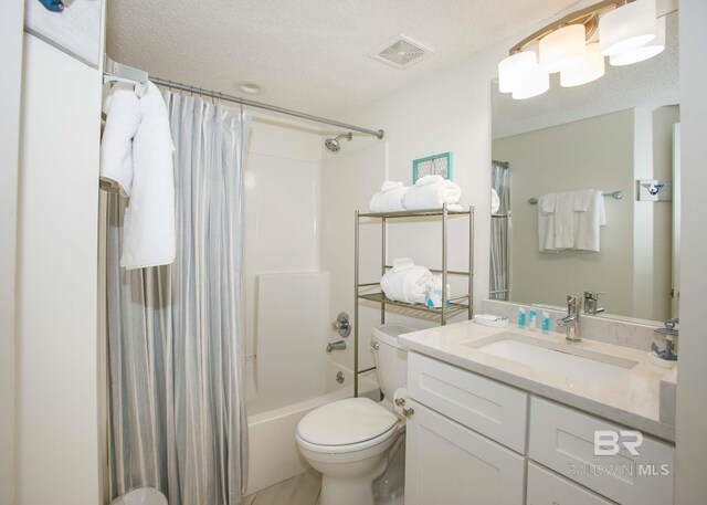 full bathroom with vanity, toilet, a textured ceiling, and shower / bath combo