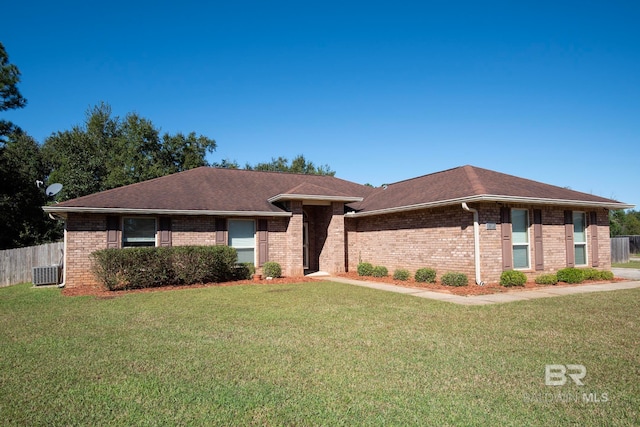 ranch-style home with central AC unit and a front yard