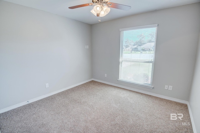 carpeted spare room with ceiling fan