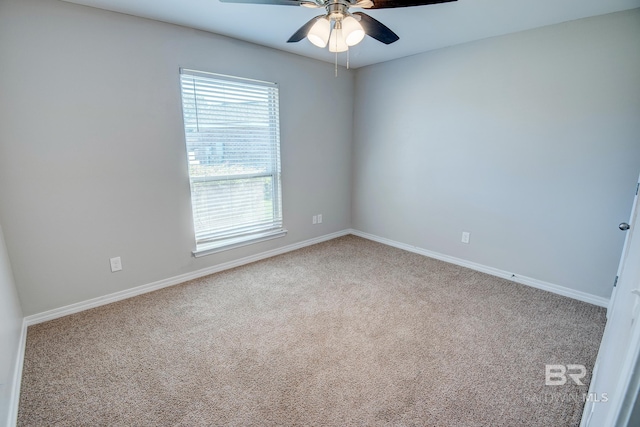 carpeted spare room with ceiling fan