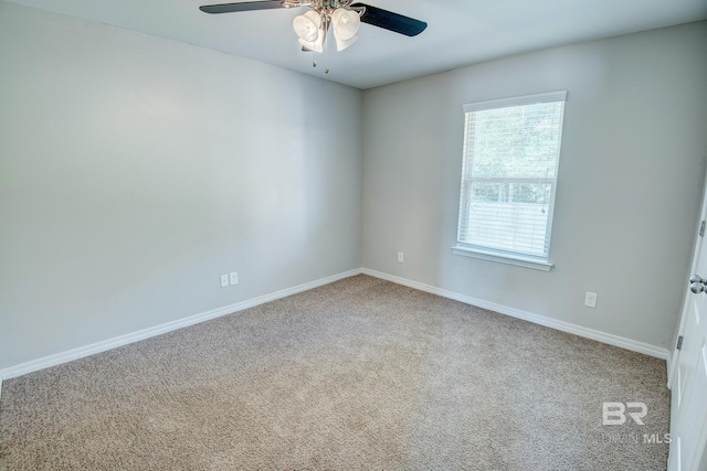 spare room featuring carpet flooring and ceiling fan