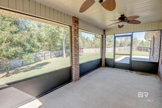 unfurnished sunroom with ceiling fan