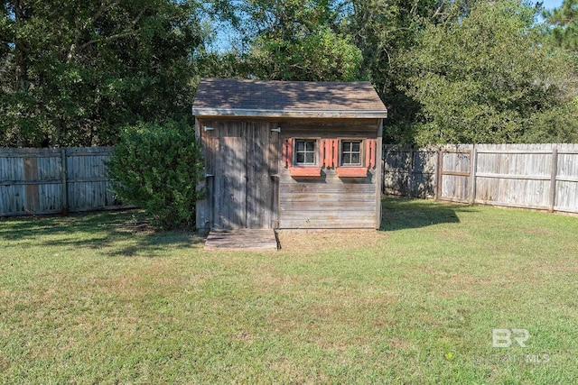 view of outbuilding with a yard