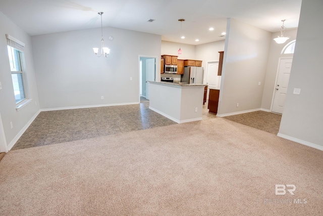 unfurnished living room with light carpet, a chandelier, and vaulted ceiling