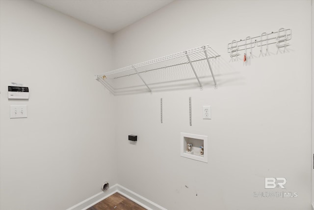 laundry room featuring baseboards, washer hookup, dark wood finished floors, and laundry area